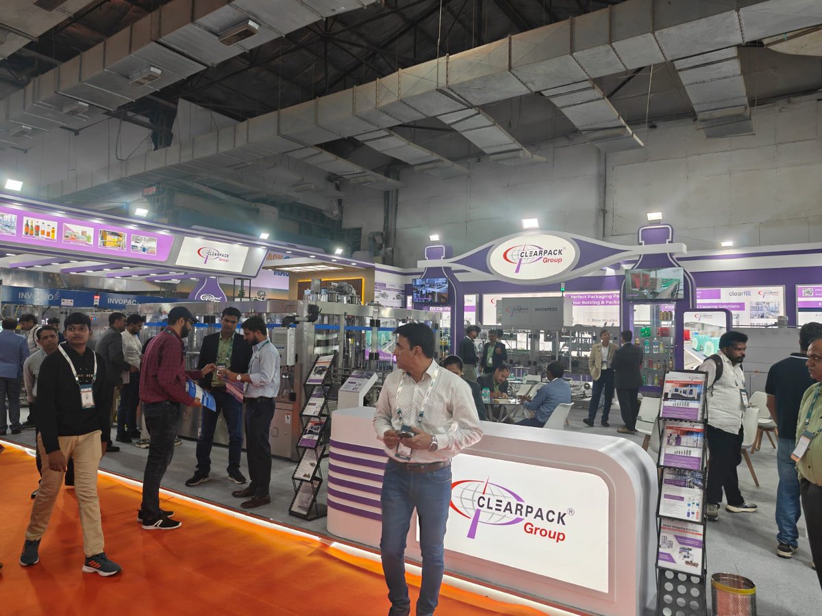 WhatPackaging's tweet image. Clearpack Group demoed its printed shrink-pack systems at #PackMachAsia Expo 2025 and @DrinkTechnology India, highlighting the shift from transparent film to registration-based printed wraps. The team also announced plans to launch its own blow-moulding machine next year.