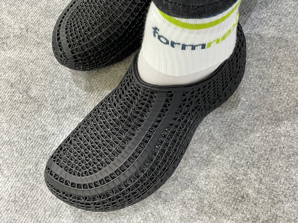 MaxFunkner's tweet image. Took my Flux 3D printed shoes by @pollyfab3d, 12.1 Booth F68, to Formnext for a proper stress test. Surprisingly comfy, especially with the official @Formnext socks! :) #formnext #formnext2025 #3Dprintedshoes