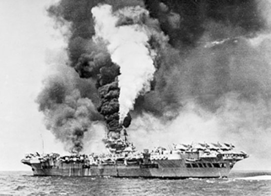 HMS Victorious on fire after being struck by Japanese kamikaze aircraft, off Sakishima Gunto (Islands), Japan, 9 May 1945
