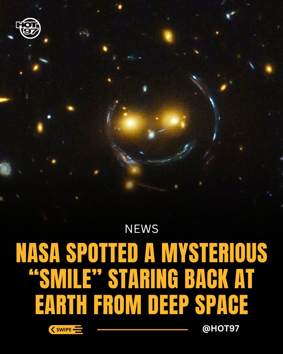 HOT97's tweet image. Hubble snapped a wild “cosmic smiley face” made from two glowing orange galaxies forming the “eyes,” a faint white glow for the “nose,” and curved arcs shaped by intense gravitational lensing that create the “smile.” These galaxy clusters are so massive they distort spacetime…