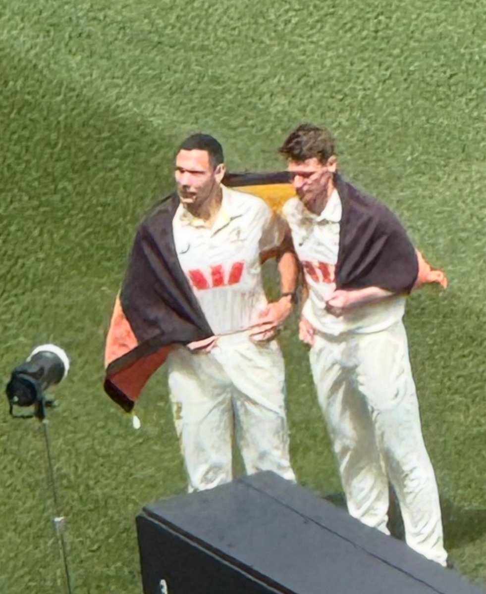 beastieboy07's tweet image. A lovely moment in Perth as @sboland24 &amp;amp; Brendan Doggett pose together wrapped in an Australian Aboriginal flag two days out from what will be the first time an Australian men’s team will go into a Test with two indigenous cricketers in the XI #Ashes