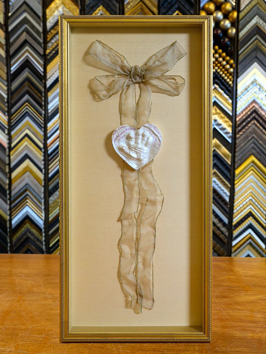 truvueglazing's tweet image. &quot;Sharing this beautiful piece, a keepsake meant to be held onto forever. We built a soft gold shadowbox around the heart-shaped hand’s imprint with a sheer ribbon and kept the design quiet so the love at its center could shine.&quot; –#UnderglassFraming #CreateSomethingSpecial #TruVue