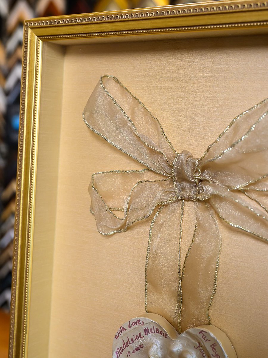 truvueglazing's tweet image. &quot;Sharing this beautiful piece, a keepsake meant to be held onto forever. We built a soft gold shadowbox around the heart-shaped hand’s imprint with a sheer ribbon and kept the design quiet so the love at its center could shine.&quot; –#UnderglassFraming #CreateSomethingSpecial #TruVue