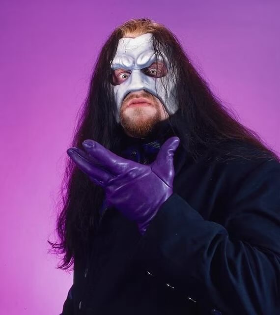 PoundingTheMeat's tweet photo. 📸 The Undertaker (Mark Calaway) started wearing the Phantom of the Opera-style half-mask in late 1995 as part of his return from an injury and a slight evolution of his “Deadman” character into the darker, more gothic “Lord of Darkness” / “Purple Glove” era.⚱️ #WWE @undertaker https://t.co/D1Xa9oFCoy