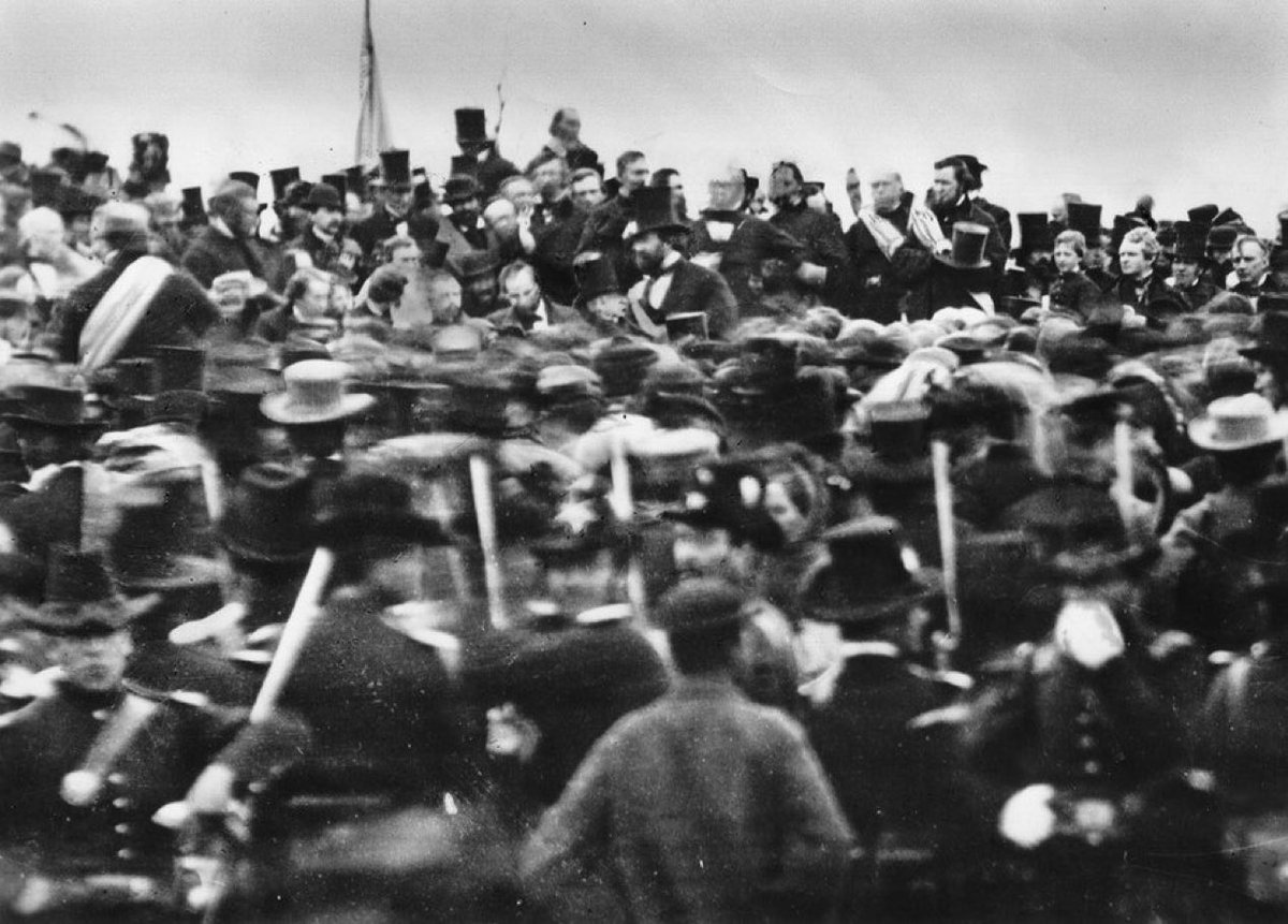 historycalendar's tweet image. On November 19, 1863, Abraham Lincoln gives the Gettysburg Address on the battlefield bearing its name. In this picture from the day, Lincoln can be seen sitting just left of center.
