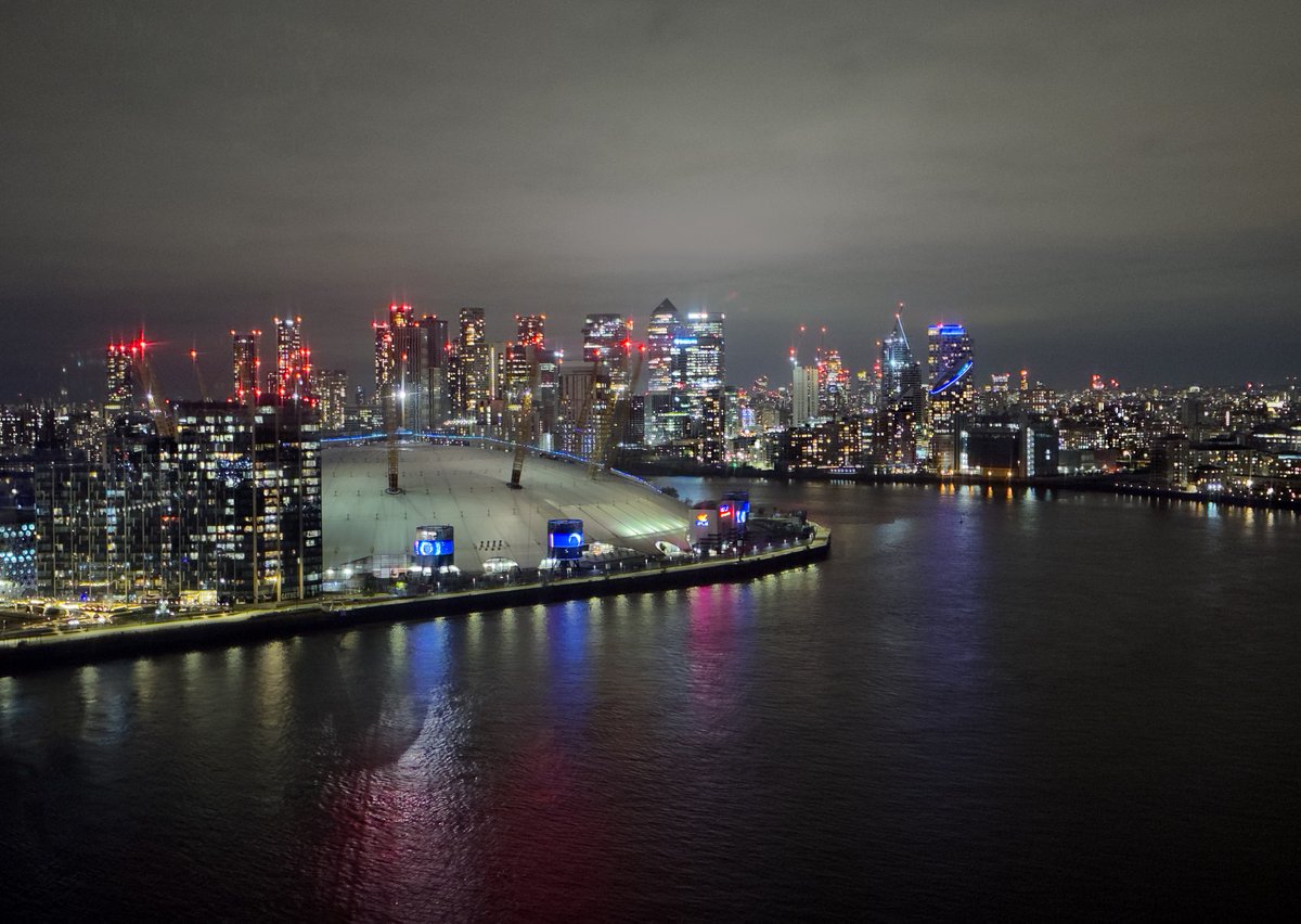 johnfielding001's tweet image. London aerial at night – the O2 Arena lit up beside the Thames with Canary Wharf glowing in the background. One of London’s most recognisable skylines, with cranes, new towers &amp;amp; reflections shimmering on the river. A modern city still growing. #London #O2Arena #aerial #image