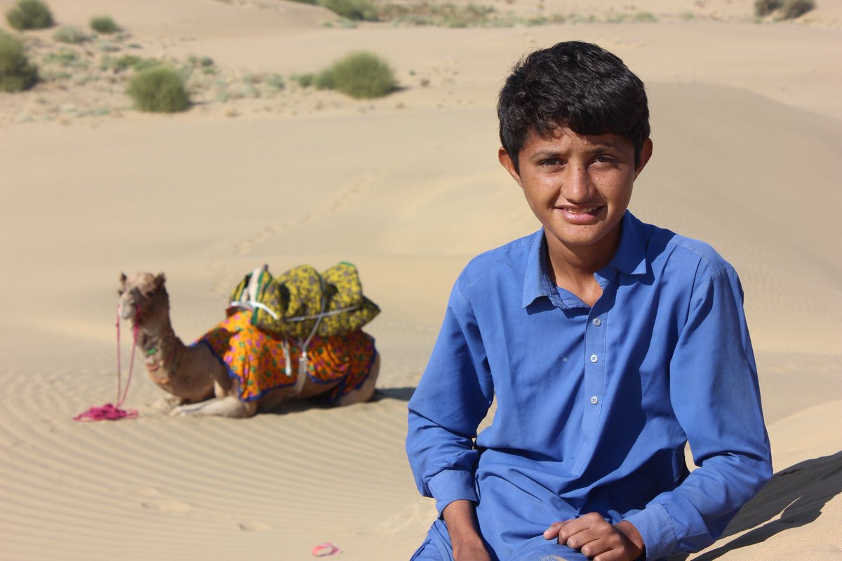 Tribal boy, lives in a hut, no school in this uninhabited desert, he tends to his camel, helps his parents survive.  
Shot on: Canon 
Photography: Manish Gupta