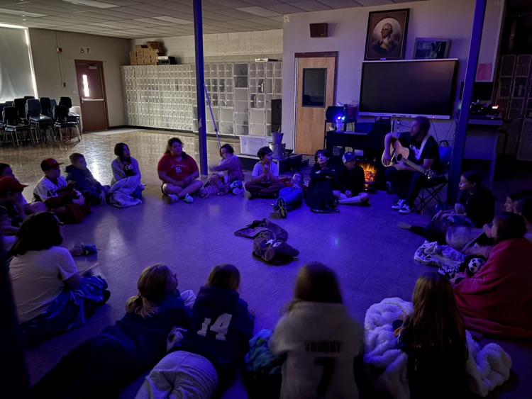 Mr. Johnson is taking his 5th grade students on a bear hunt and signing songs around the camp fire
