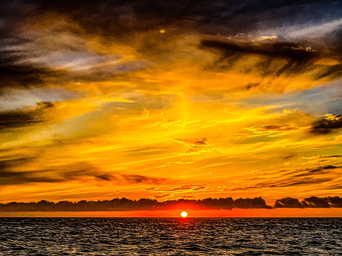 The sun bows low, its colors spread wide,
Painting calm where worries hide.
Each fading ray whispers soft and true,
A promise that hope will shine for you.