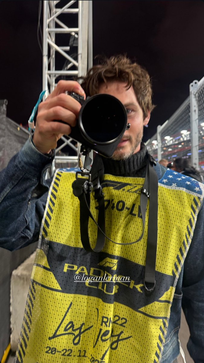 logan lerman went to watch some cars go zoom. baby nobody looking at those damn cars.