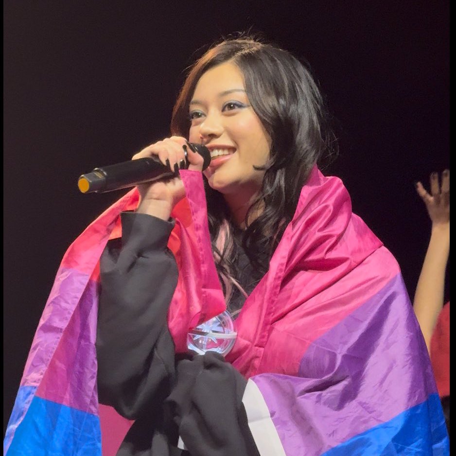 leiforteza's tweet image. megan wrapping the bi flag around herself with the biggest smile on her face is making me so emotional like i’m actually not ok