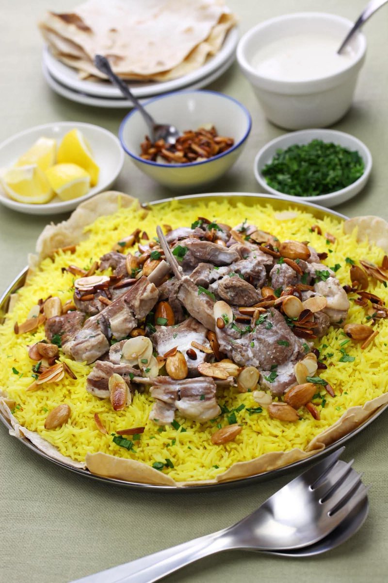 Dr_TheHistories's tweet image. Mansaf is the national dish of Jordan 🇯🇴, also eaten in Syria and Saudi Arabia (northern regions). It is a traditional festive meal consisting of tender lamb or goat meat cooked in a creamy sauce made from fermented dried yogurt, known as jameed. 

The meat is slowly cooked in…