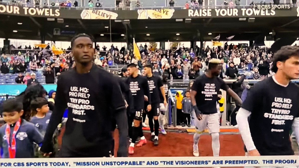 benwright's tweet image. Players from FC Tulsa and Pittsburgh Riverhounds walk onto the field for the USL Championship final wearing shirts saying “USL HQ: Pro Rel? Try pro standards first.”

USL HQ has announced a new first-division league including promotion &amp;amp; relegation in 2028.