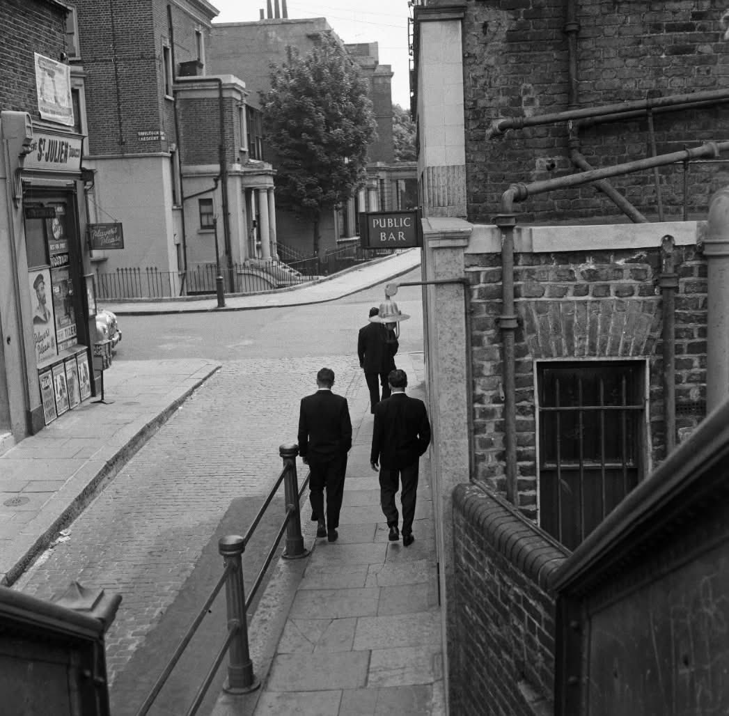 Crossing over the railway footbridge towards Tavistock Crescent from Acklam Road, 1959. The Tavistock Arms Pub (later to feature in “Hell W10“ and “Withnail &amp; I”) is on the right. All of this is gone now.