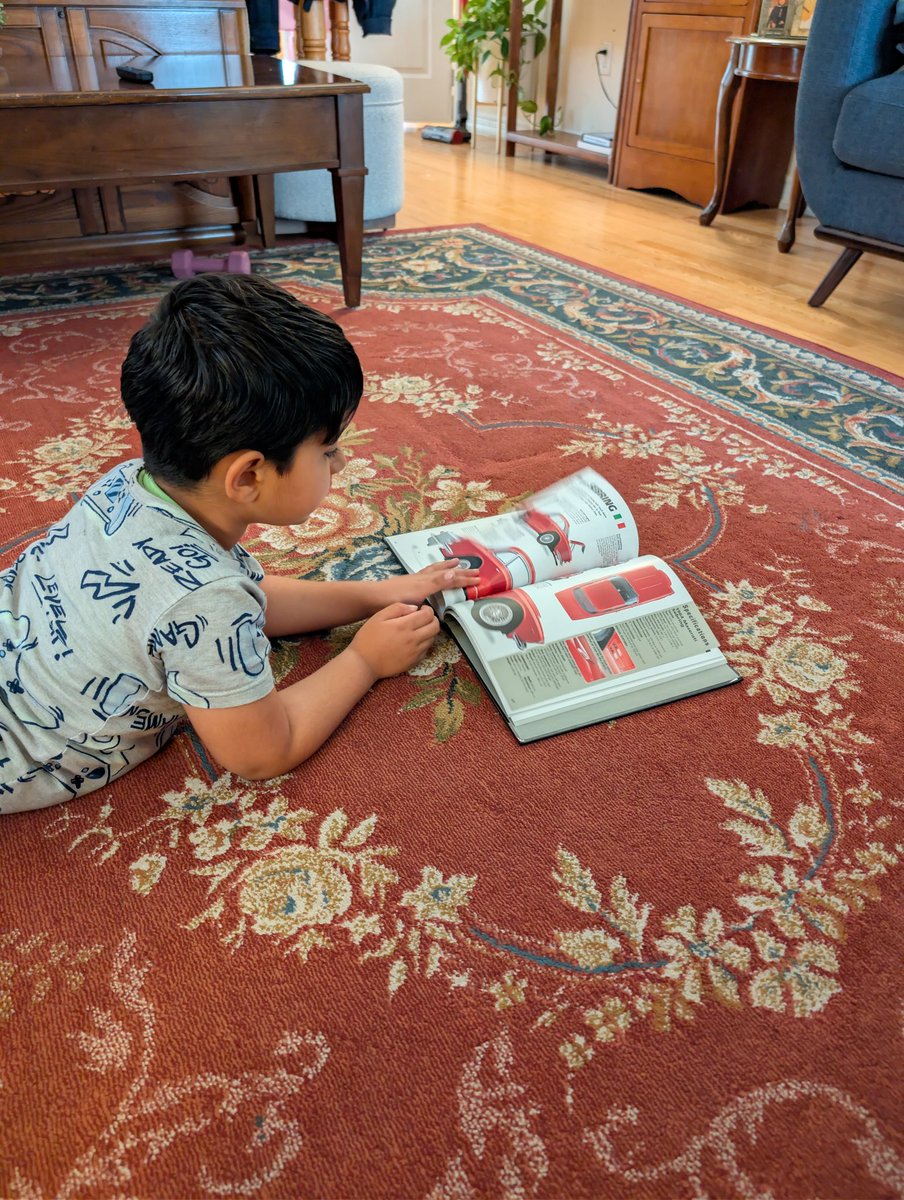 gauravbhangoo's tweet image. My son&apos;s fav pastime. Scrolling over my car books, drooling at the pictures and asking, &quot;is this one faster than that one ?&quot; #cars #Automotive #automobile