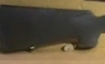 Would a forensic team put a rifle in a cardboard box then photograph it? What does the peanut do?