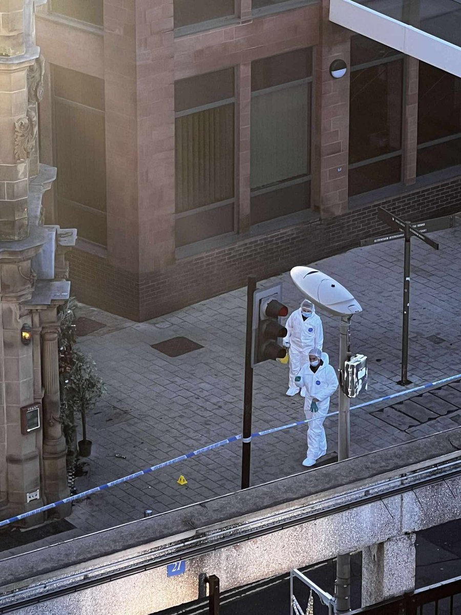 🚨 SHOCKING: Altrincham town centre locked down at dawn with dozens of armed officers, forensics in white suits, and ambulances screaming in after two men left fighting for their lives just yards from the hospital.

Locals say it kicked off in the early hours – police now