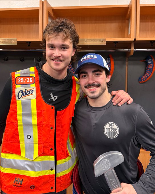 Connor Clattenburg wearing the vest and Matt Savoie holding the pumpjack. 