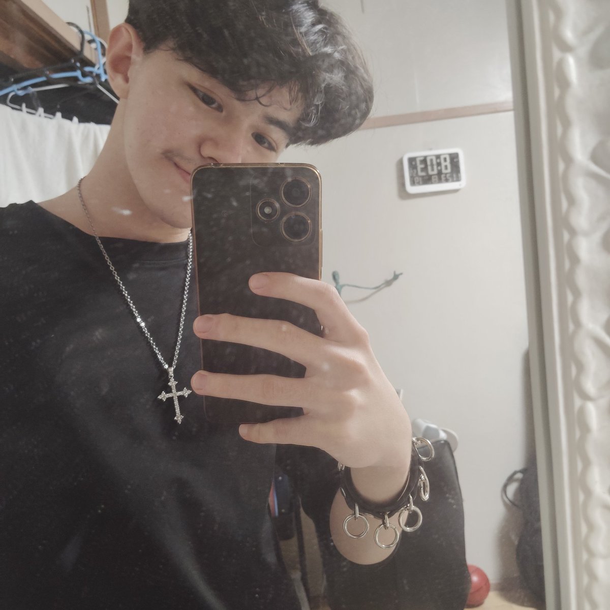 My mom bought me a cross necklace and a punk bracelet of rings, i love accessories.