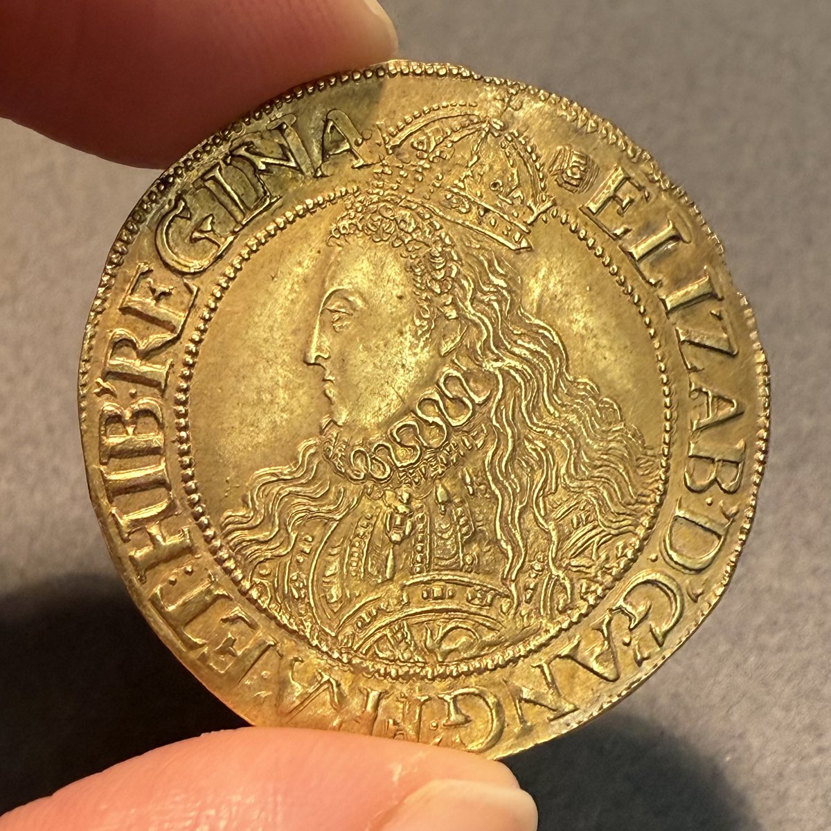 Queen Elizabeth I is depicted wearing an elaborate dress on this gold half-pound that was minted in the final years of her reign (1592-1595). This specimen is from the Hunterian collection.