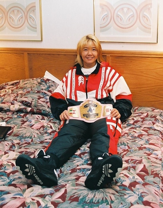 #OnThisDay in 1994: Bull Nakano holding the WWF Worlds Women's Title belt in her hotel room.