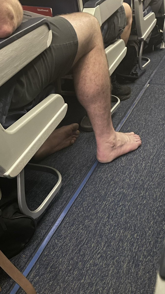 Homodrome.com flying home from Palm Springs this dude need to let them breathe ! #mensfeet