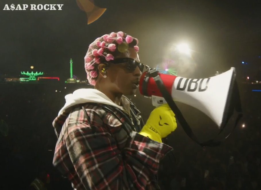 simsgazette's tweet image. 🚨| ASAP Rocky is wearing Sir Lewis Hamilton's official Mercedes-era race gloves for his appearance at Tyler, the Creator's Camp Flog Gnaw festival.