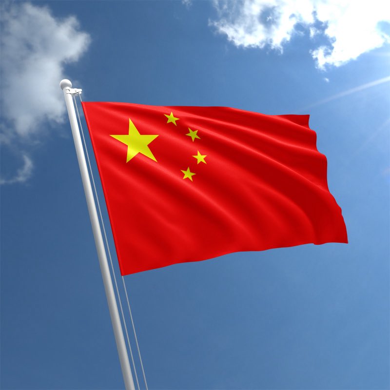 Chinese flag waving in the sky, symbolizing China's Bitcoin mining resurgence