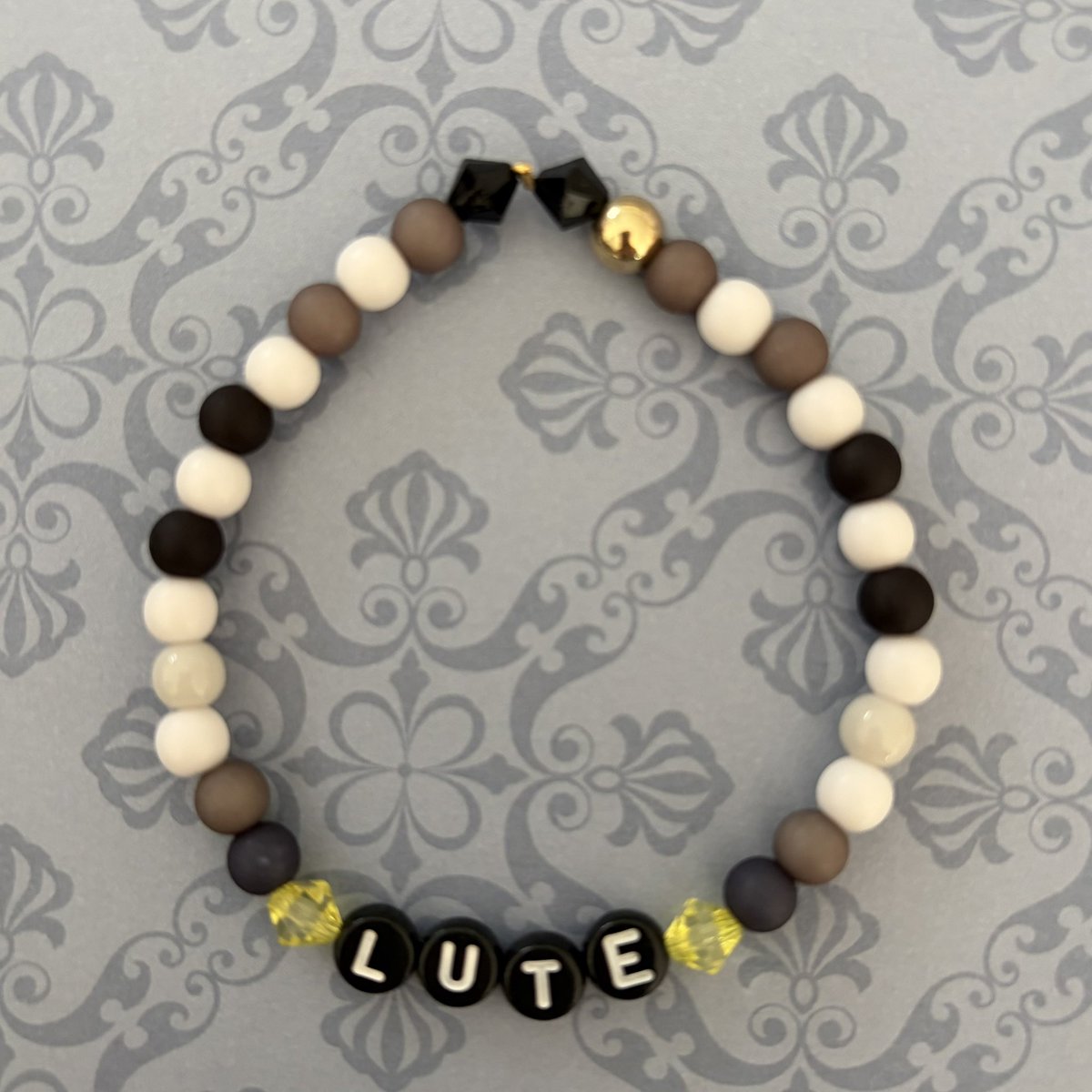 HelluvaCraftDE's tweet photo. 😇⚔️ATTENTION.⚔️😇
This is Lute. A bracelet inspired by me has been released.
It is… suitably crafted. Neat. Precise. Acceptable.

😇 https://t.co/cD88QvX2HS 😇

If you intend to wear it, do so with dignity. Don’t tarnish Heaven’s image.
#HazbinHotel https://t.co/owfca5rAaP