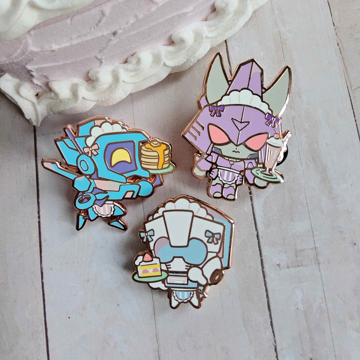 plushisheep's tweet photo. Welcome to the Lost Light Cafe! Whirl, Tailgate, and Cyclonus Tailgate enamel pins will be in the shop drop tomorrow!🍰 https://t.co/IAJFMZBJBs