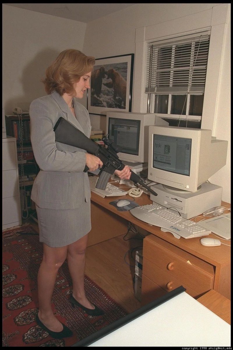 PostinClips's tweet image. Woman pointing a gun at a computer for some reason, 1998