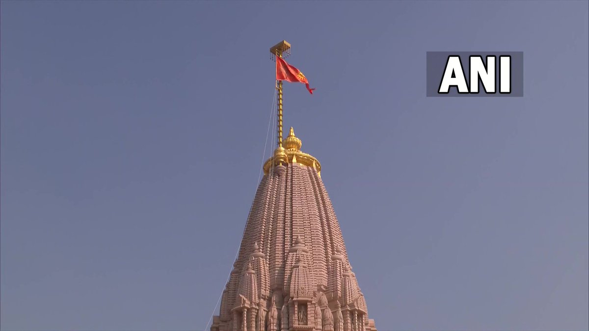 ANI's tweet image. Ayodhya Dhwajarohan | The Dharma Dhwaj, measuring ten feet in height and twenty feet in length, bears the image of a radiant Sun symbolising the brilliance and valour of Lord Shri Ram, with an ‘Om’ inscribed on it along with the image of the Kovidara tree. 

(Pics: DD)
