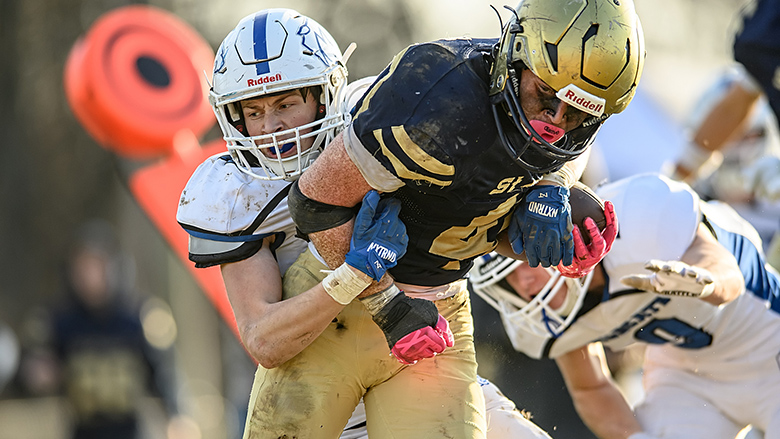 myleaderpaper's tweet image. St. Pius X junior running back Cody Shaver carries Montgomery County’s Wyatt March into the end zone for a Lancer touchdown in the Class 2 state quarterfinals Nov. 22. Shaver carried the ball 28 times for 131 yards and increased his single-season school record to 2,776.