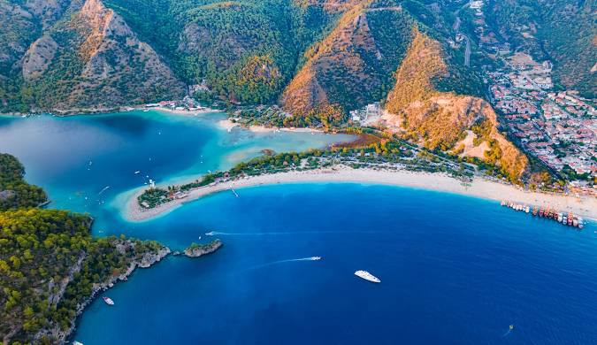 Ölüdeniz is a resort village on the southwest coast of Turkey. It’s known for the blue lagoon of Ölüdeniz Tabiat Parkı and the wide, white Belcekız Beach. Overlooking the village is Babadağ mountain from where paragliders take to the skies.