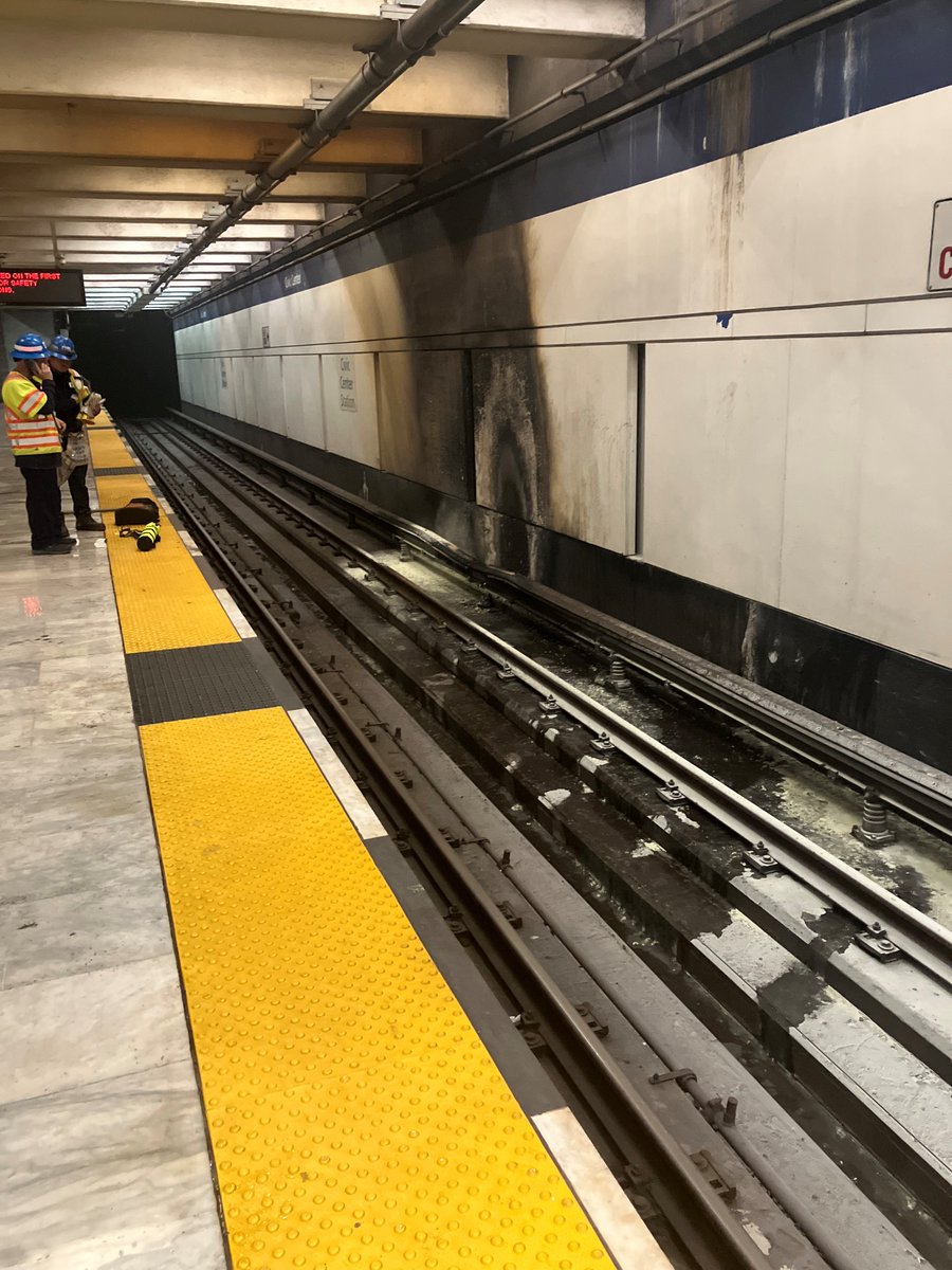 Here is a photo of the damaged third rail from the earlier blown insulator. 

Trains continue to run on the opposite track while crews repair the trackway.