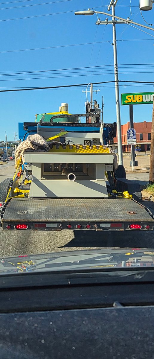 What IS IT!?!?!?
I was behind this guy for about 45 minutes and the best I can come up with is a CNC machine. Maybe just the blue part.
It's like one of those pictures that shows what it looks like for someone who has had a stroke. Indistinguishable items &amp; shapes. My brain hurts
