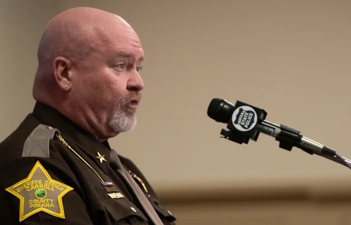 UP NEXT - Sheriff Tony Liggett, Carroll County’s own walking bucket of lukewarm mayonnaise in a cowboy hat. This man looks like the final boss of every rural Indiana Cracker Barrel: 300 pounds of fried pork tenderloin stuffed into a polyester uniform that’s been screaming for