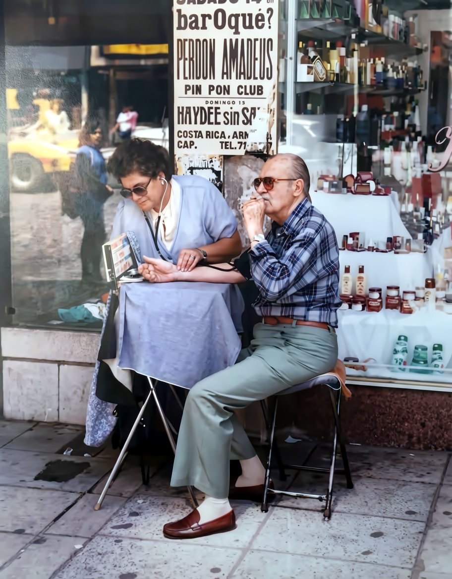 <a href="/cremetoursBA/">Vanessa Bell</a> That irony of smoking while getting blood pressure taken is peak Buenos Aires! 🇦🇷🚬

Your dad had a great eye. I ran the photo through rephoto.app to sharpen up the scene—the details on that pharmacy window and the poster really pop now. Hope you enjoy the clearer