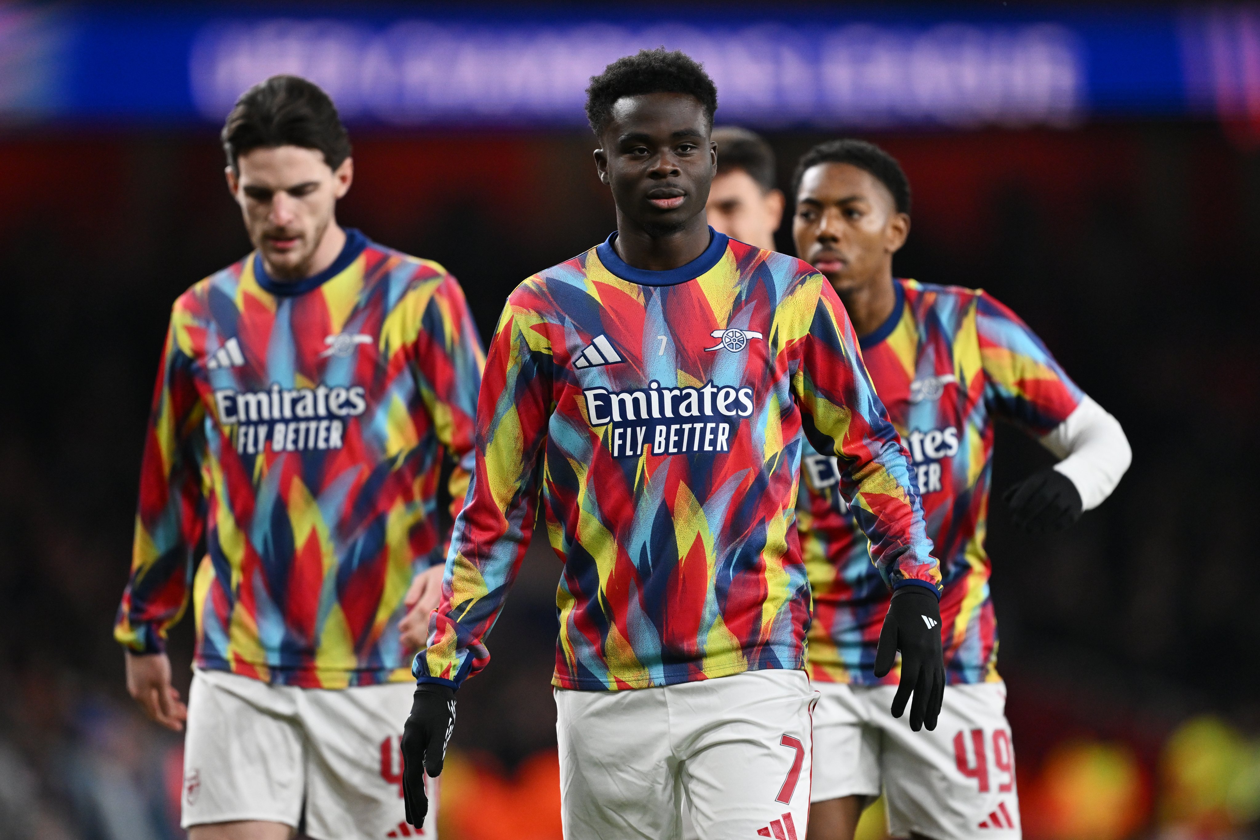 Bukayo Saka, Declan Rice and Myles Lewis-Skelly run through their warm-ups.