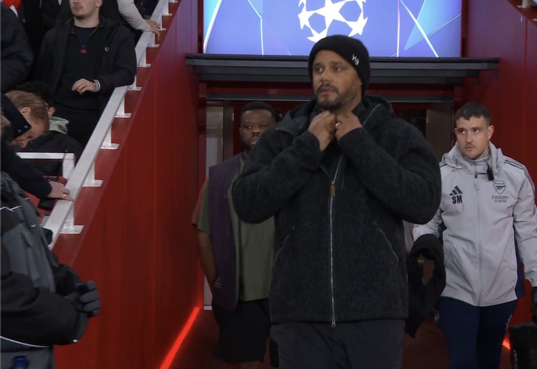 TouchlineX's tweet image. 📸 - Vincent Kompany with the cap on his head and the Champions League logo behind him.

His aura is unmatched.