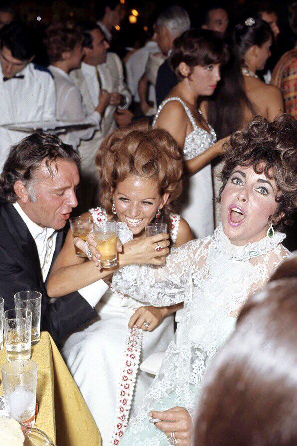 Richard Burton, Claudia Cardinale and Elizabeth Taylor during a party in Venice in 1967.