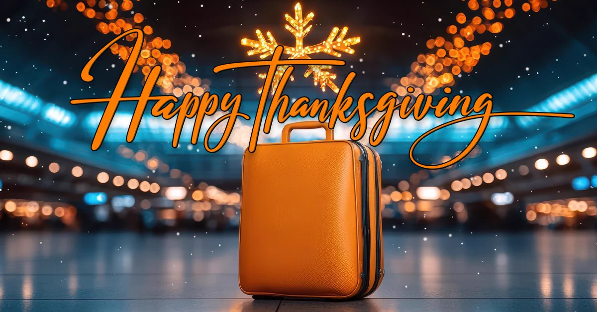 Orange roller bag in the middle of an airport terminal decorated for Thanksgiving, with the text “Happy Thanksgiving” displayed in the center.  