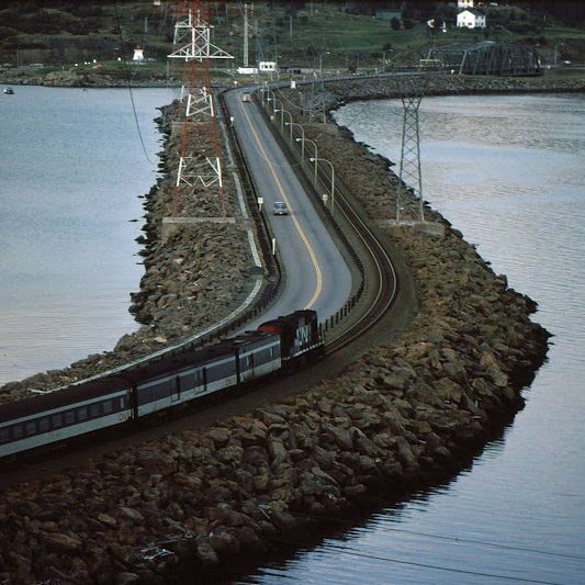 CraigBaird's tweet photo. The Canso Causeway was built as part of the Trans-Canada Highway construction in Nova Scotia. This 1.5 kilometre long rock-filled causeway cost $23 million and connected the Nova Scotia Peninsula with Cape Breton Island.
This is its story.

Long before the Canso Causeway was built, ferries were used to transport people and things across the strait. 
As early as the 1890s, there were talks of building a bridge across the strait. One proposal was for a 1.3 km steel cantilever bridge.

After the Second World War, renewed proposals for a bridge were put forward but it was decided that due to the amount of ice in the winter and the strong currents, constructing a bridge was not feasible. 
A causeway was chosen as a better option instead.

When Nova Scotia signed the agreement to build a portion of the Trans-Canada Highway in the province, part of that agreement included federal financial assistance for building the causeway. 
Estimates on the work were put at $22.75 million to complete the project.

The Canso Causeway Project began on Sept. 16, 1952 in a grand ceremony.
As soon as construction began, the communities of Mulgrave, Point Tupper and Port Hawkesbury began to boom with so many workers coming into the area for the project. 

On Dec. 10, 1954, the Strait of Canso was permanently blocked by the construction.
Occasionally, since maps still showed a strait, some ships ran aground on the causeway. On Nov. 28, 1954, a 2,200-ton Norwegian freighter ran aground. It took a day to refloat the ship. 

On April 13, 1955, the Causeway was officially finished. Five days later, a CNR work train drove across the causeway. On May 14, 1955, regular train service began on the causeway. 
Six days later, the roadway was opened to traffic.

The roadway was 2.1 km long, 24 metres wide at the top and 198 metres wide at the bottom. A sidewalk was also built along the roadway.
On Aug. 13, 1955, 35,000 people came out for the grand opening. It included 100 bagpipers walking across the causeway.

The final cost of the causeway came to $19,490,000. Of that, the federal government paid $14,780,000.
Part of the cost was paid off through the use of tolls from 1955 to the early-1990s. 
The government also had to pay out a lot of money in a lawsuit.

Alistair Fraser, the Lt. Governor of Nova Scotia, launched a $5 million lawsuit against the federal government due to gravel and earth being removed from his property for the project. Over 10 million tons was removed, for which the government offered $5,000.

Fraser, a decorated First World War soldier who served at Vimy Ridge, kept at his lawsuit for years. In 1963, the Supreme Court ruled he be awarded $560,000. 

Learn more about the Causeway in my book 👇 
https://t.co/Yq48uHYqcf 

I hope you enjoyed that look at the construction of the Canso Causeway!

If you enjoy my Canadian history content, you can support my work with a donation at 👇
https://t.co/1bARpMfNGq

Sources:

Parks Canada: https://t.co/sqW8ImGW2x 
Historic Nova Scotia: https://t.co/sts7nNuKtI 
Canadian Encyclopedia: https://t.co/35GXtlTCnB 
Canada's Main Street - Craig Baird