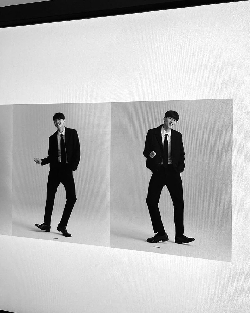 Dozyun's tweet image. He stood in the studio with a calm, effortless confidence, his relaxed posture enhancing the clean and minimal atmosphere around him. The monochrome setting highlighted the soft textures of his sweater and the crisp look of his white pants.