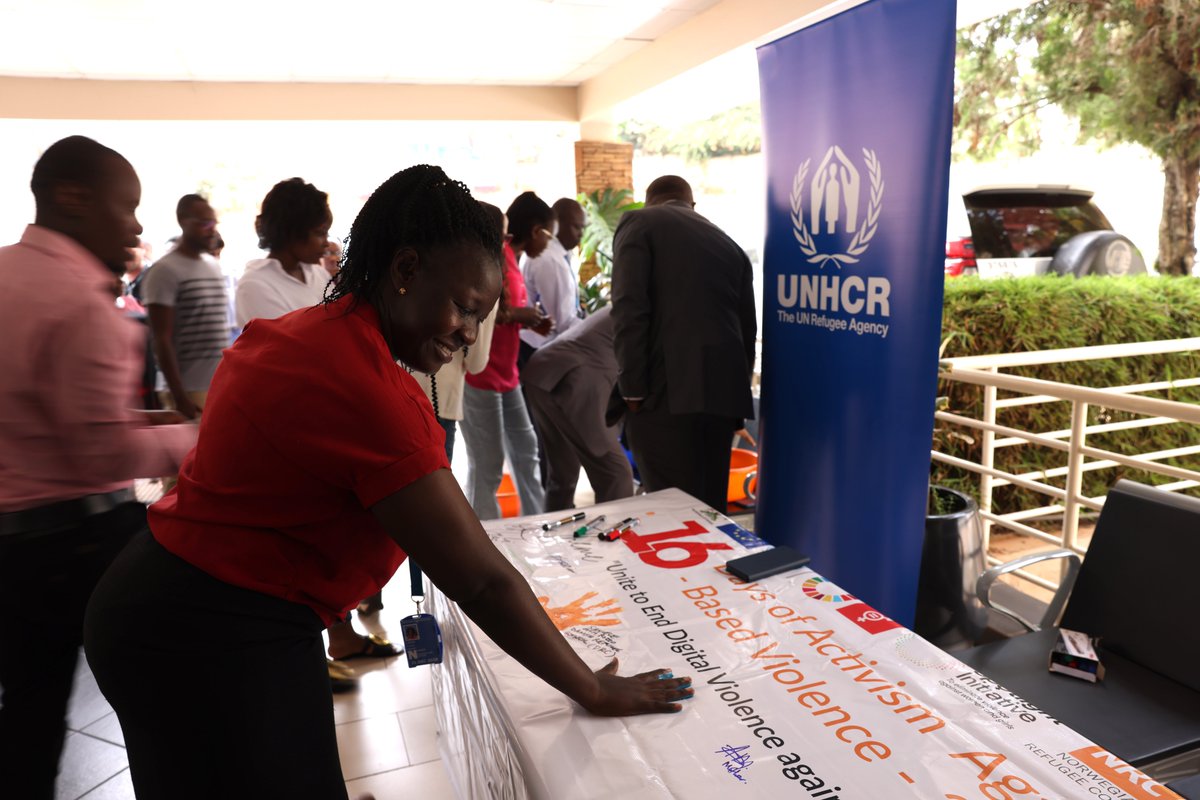UNHCRuganda's tweet photo. @UNHCRuganda staff signed the commitment banner, reaffirming the stand against Gender-Based Violence under the theme: End Digital Violence Against Women and Girls. 🧡✊ https://t.co/7MZIYiQGEy