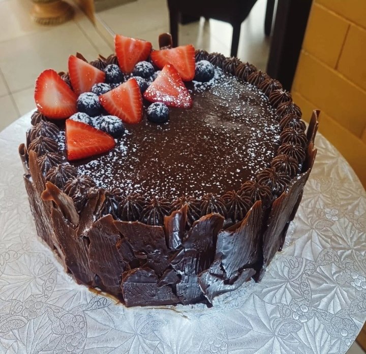 Strawberry chocolate log cake...

Thinking of selling this for Christmas. Chocolate sponge with chocolate buttercream and strawberry compote between the layers &amp; around the cake , topped with chocolate ganache, berries and a dusting of icing sugar...