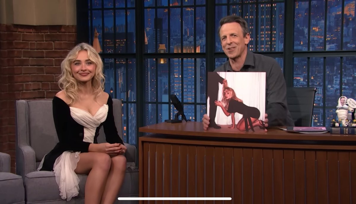 Sabrina sitting with her 6X grammy nominated album