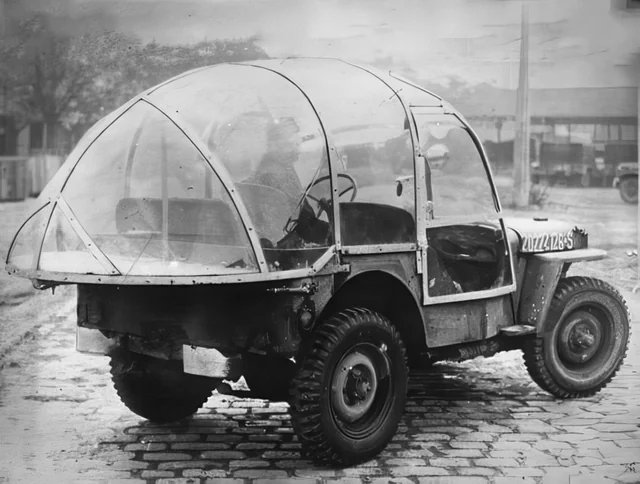 historyinmemes's tweet photo. The American winter jeep - soldiers of the 644th Ordnance Depot using one ‘of the cars which has been fitted with a plastic, tear-drop enclosure complete with wipers, spotlight and screen defroster, 1945. https://t.co/dAQq4GVDHI