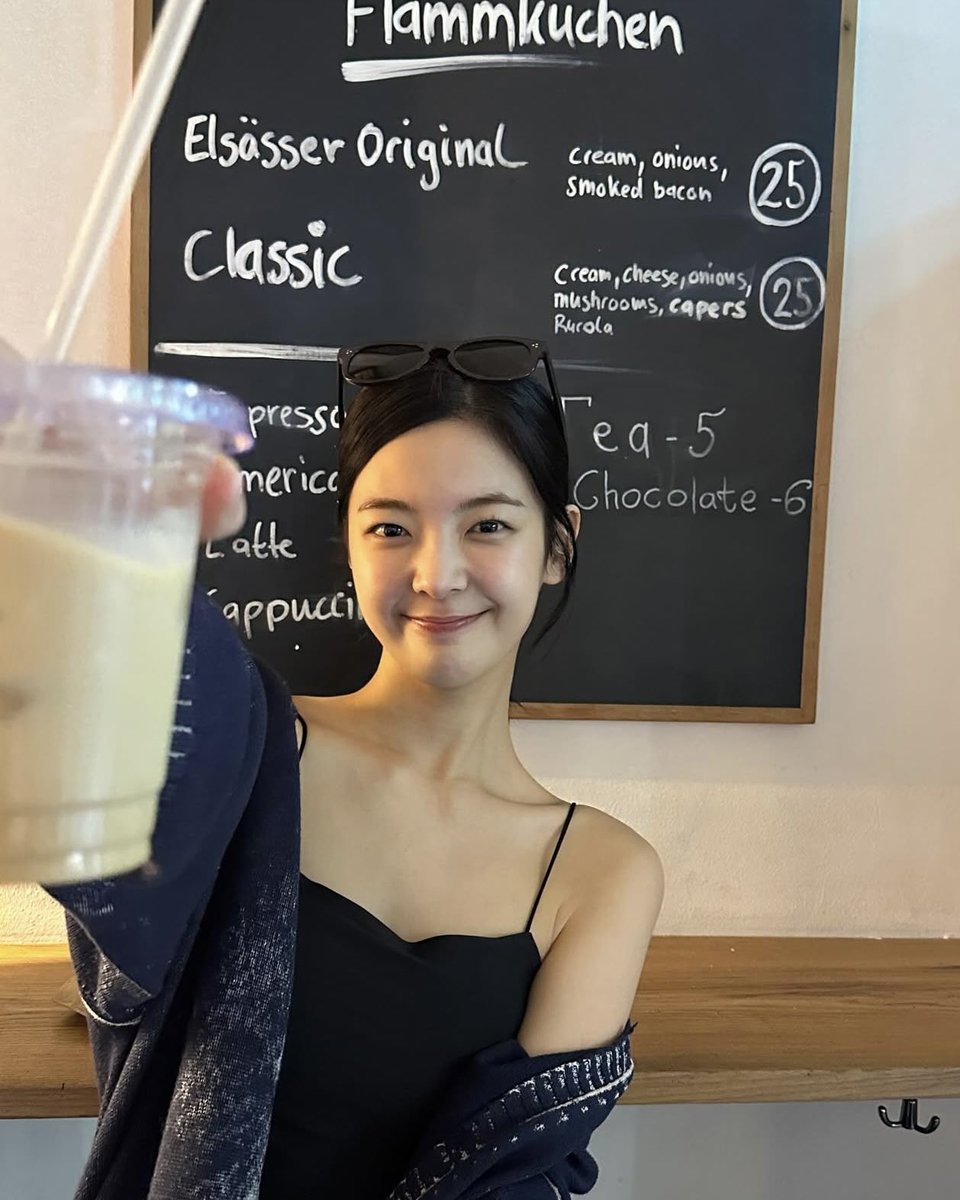 The café was dim and darling. I looked like I’d just wandered out of a summer ache, sun still warm on my collarbones. Ordered an iced coffee with too much milk, sat in the corner, and let the chill climb my wrist. I drank it like it’d keep me soft in a hardening world—and it did.