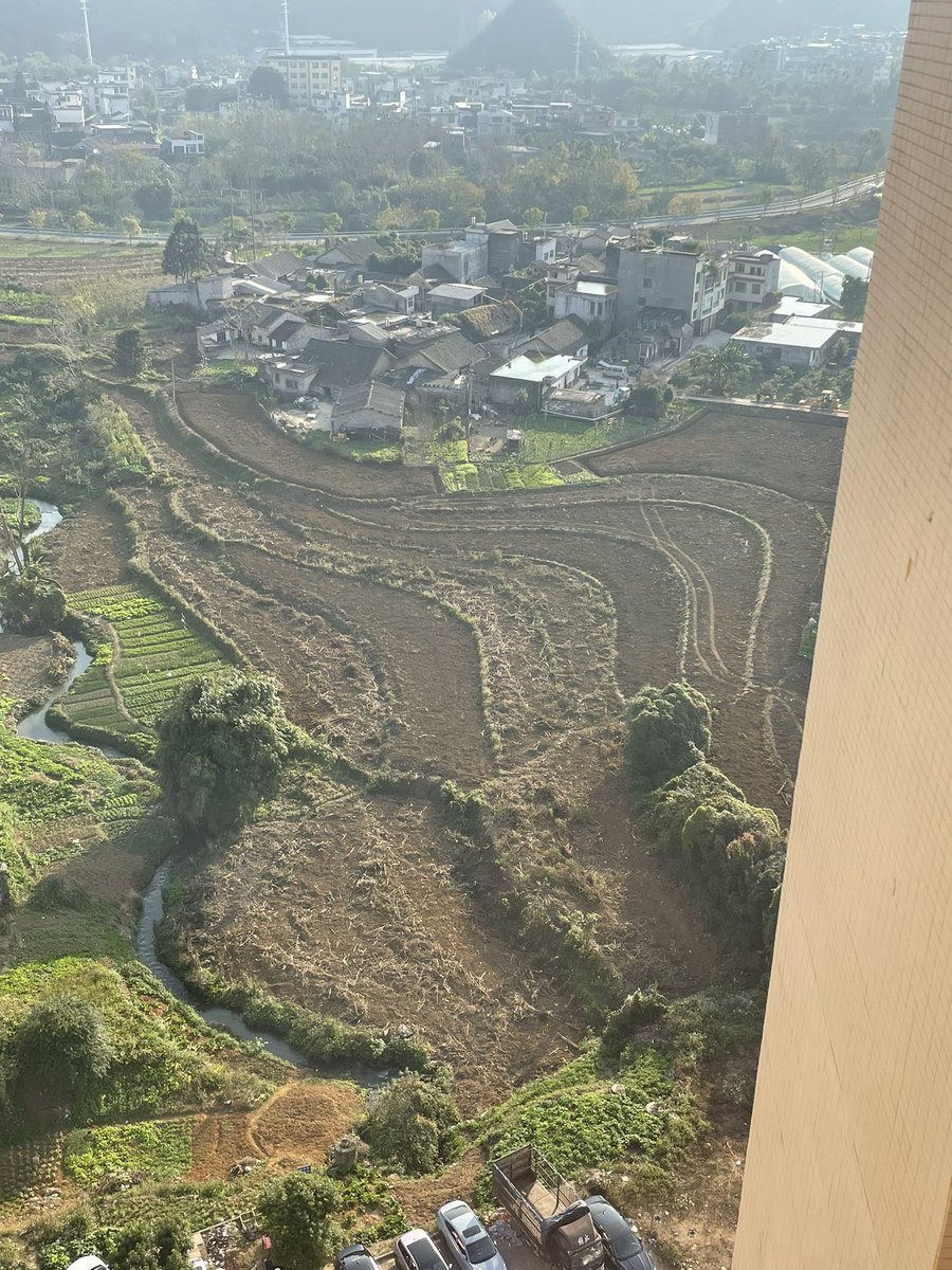 Plots of small farm land below my window. Note they’ll farm on any small plot. And on the side of the hill too! 

I’m told each of those curvy plots belongs to a different farmer. How did that ever get laid out like that?
